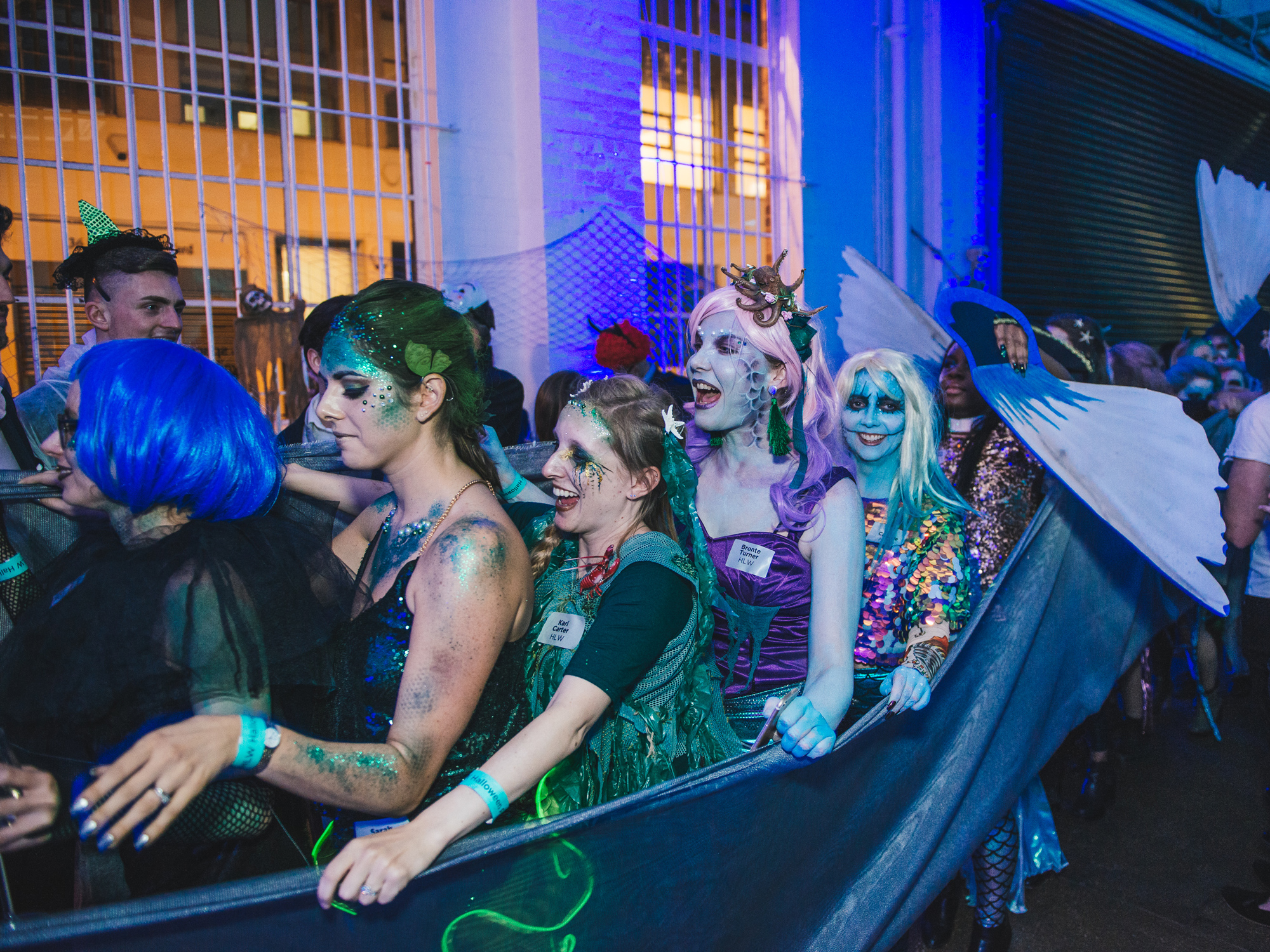 Costumed participants of an event portraying mythical creatures, bonded together as part of an elaborate costume.