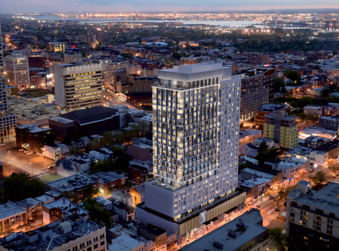 Twilight cityscape with high-rise buildings illuminated from within, showcasing varied architectural styles and grid street layout, highlighting urban density and mixed-use development.