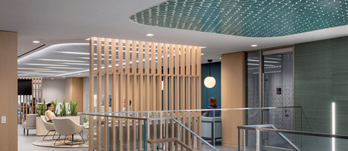 Modern office lobby featuring a natural wood slat partition, a wavy blue ceiling design, sleek glass railings, and minimalist furniture, illuminated by soft, ambient lighting.