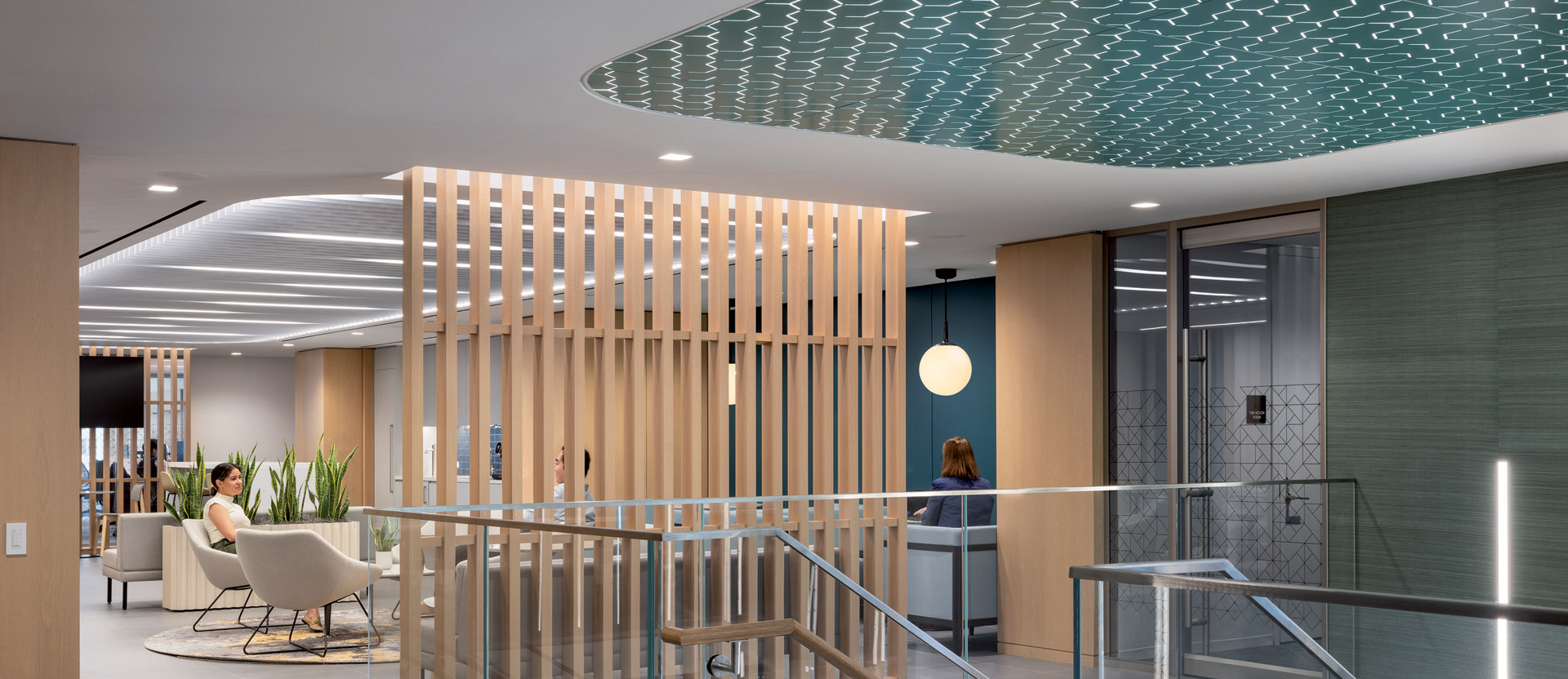 Modern office lobby featuring a natural wood slat partition, a wavy blue ceiling design, sleek glass railings, and minimalist furniture, illuminated by soft, ambient lighting.