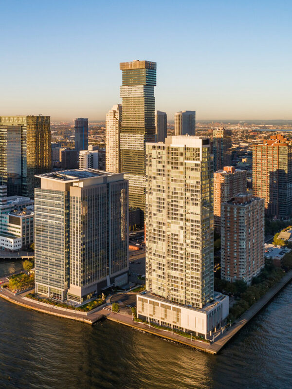 A stunning aerial view of the New Jersey city skyline as seen from the water, showcasing commercial buildings.