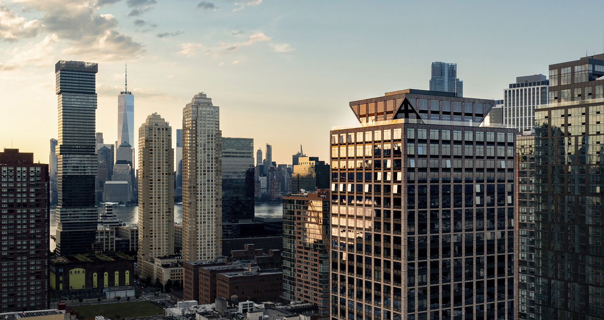 New York and New Jersey city skyline against an overcast sky adorned with fluffy white clouds