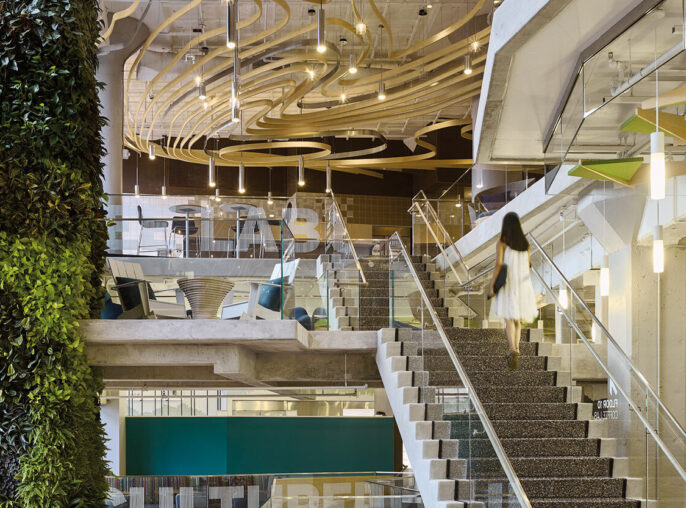Interior of Google Commons with staircase and green pant wall
