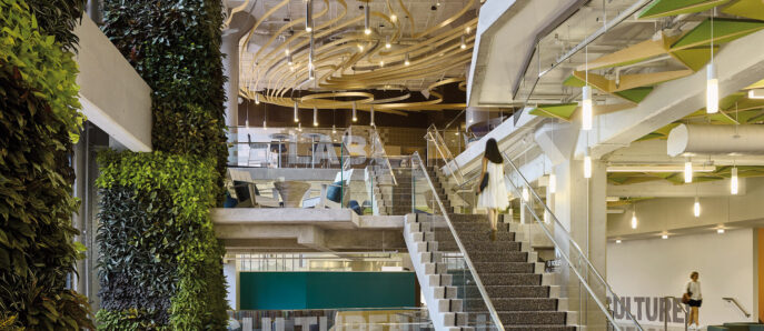 Interior of Google Commons with staircase and green pant wall