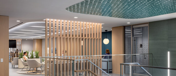 Modern office lobby featuring a natural wood slat partition, a wavy blue ceiling design, sleek glass railings, and minimalist furniture, illuminated by soft, ambient lighting.