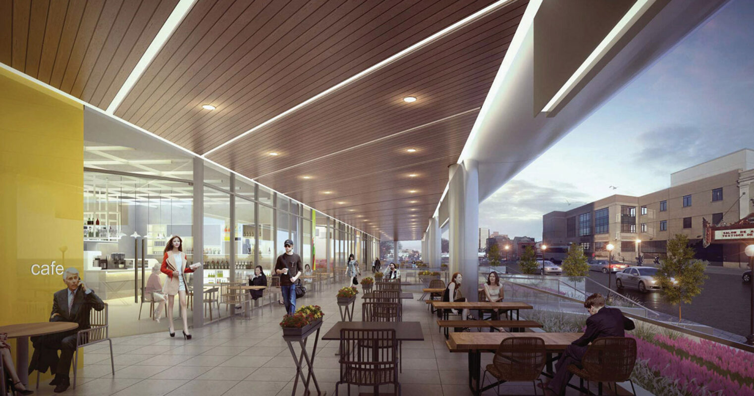 Spacious outdoor café under a wood-paneled overhang with recessed lighting, featuring modern furniture, communal tables, and vibrant planters along a manicured walkway.