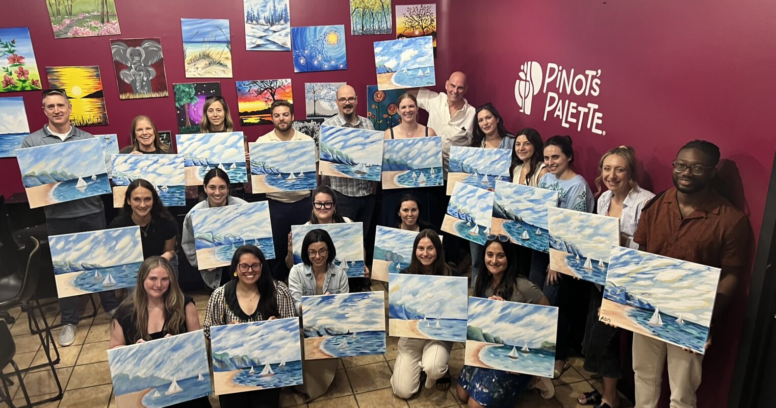 HLW team members display completed paintings during a creative workshop, showcasing collaboration, artistic exploration, and team building within the design community.