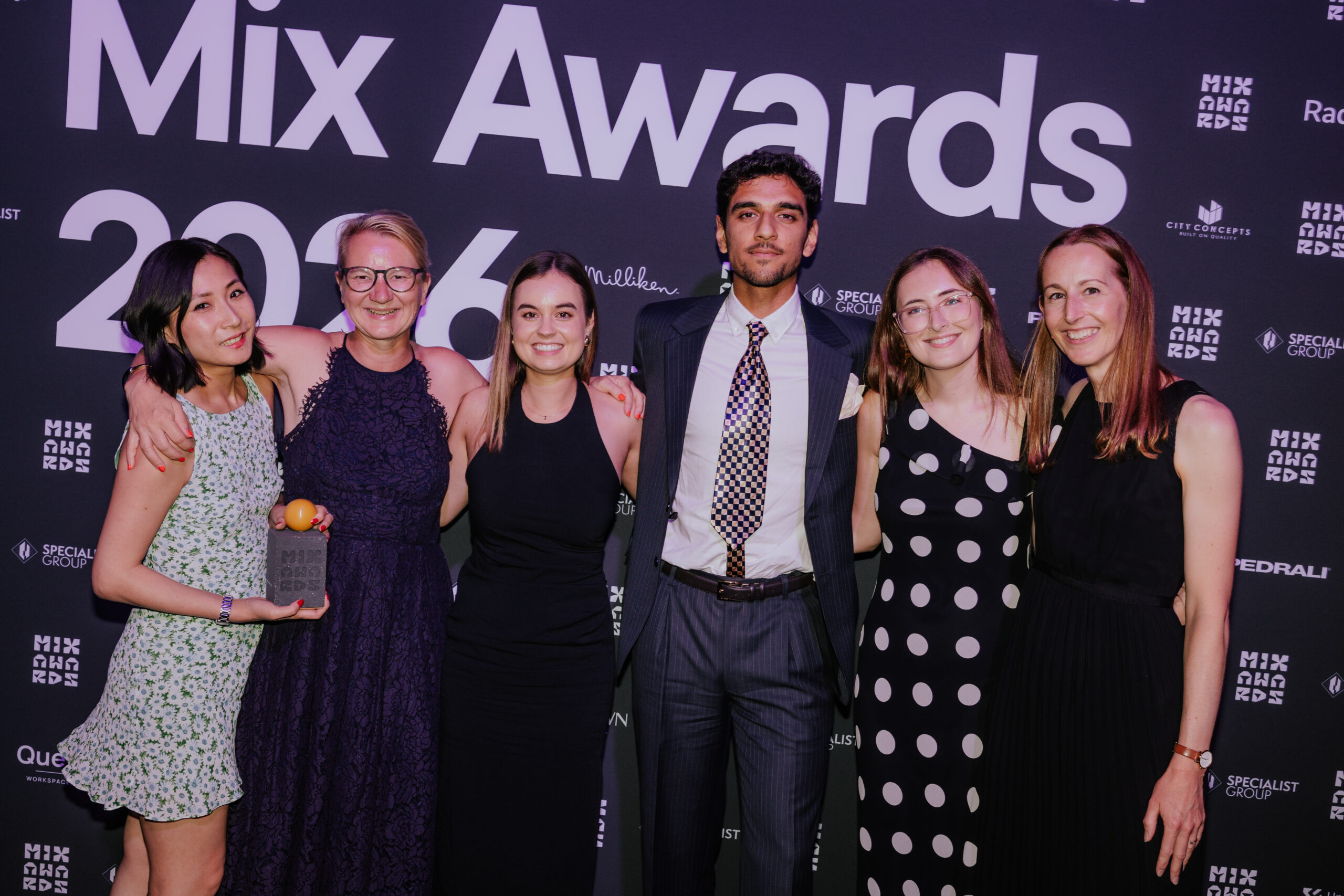 HLW team members pose with an award at the Mix Awards event, celebrating industry recognition and excellence in architecture, interior design, and workplace innovation.